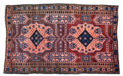 Lot 1354 - Balouch rug, West Afghanistan, the abrashed chocolate and chestnut field with two salmon medallions