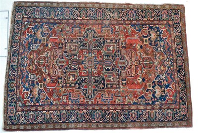 Lot 1356 - Early 20th century Heriz carpet, Iranian Azerbaijan, the madder field of angular vines around...