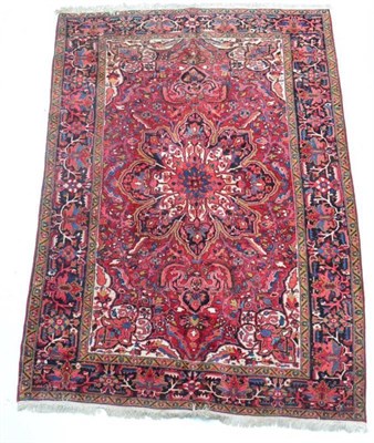 Lot 1361 - Heriz carpet, Iranian Azerbaijan, the raspberry field of vines around a pole medallion framed...