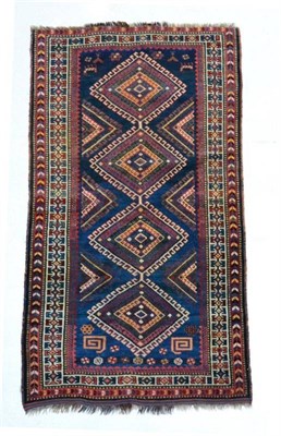 Lot 1370 - Luri rug, West Iran, the indigo field of latch hook diamond medallions framed by zoomorphic and...