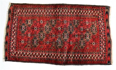 Lot 1374 - Mashad Balouch rug, North Khorasan, circa 1900, the madder and walnut honeycomb lattice field...