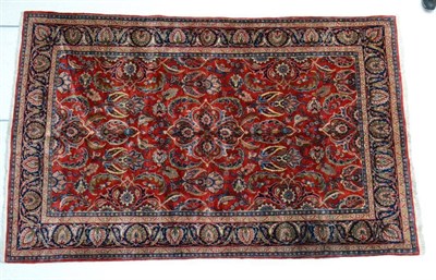 Lot 1379 - Saroukh carpet, Central Iran, the brick red field of scrolling serrated leafy vines enclosed by...