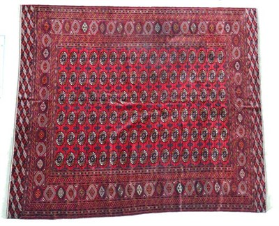 Lot 1384 - Tekke carpet, North West Afghanistan, the blood red field with columns of guls enclosed by...