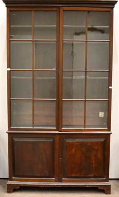 Lot 1402 - Late George III mahogany bookcase, with glazed doors enclosing four adjustable shelves, the...