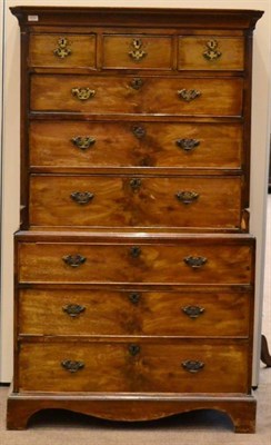 Lot 1419 - ^ A George III mahogany chest on chest, early 19th century, with a moulded cornice above three...