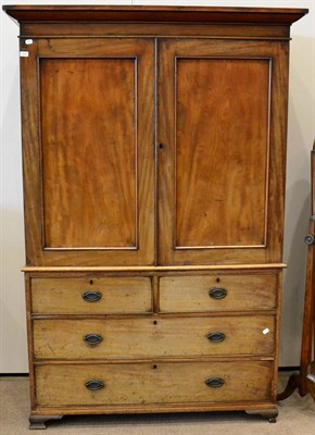 Lot 1424 - ^ A George III mahogany linen press, early 19th century, with two cupboard doors enclosing four...