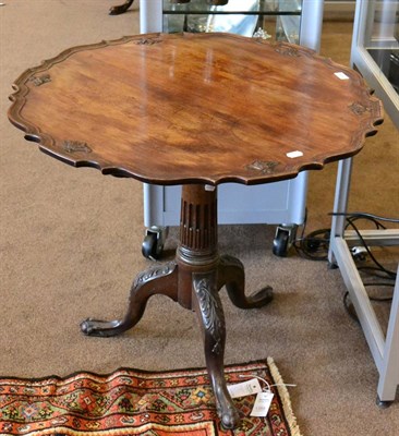 Lot 1430 - ^ A George III mahogany tripod table, the moulded top raised on a stop-fluted column support,...