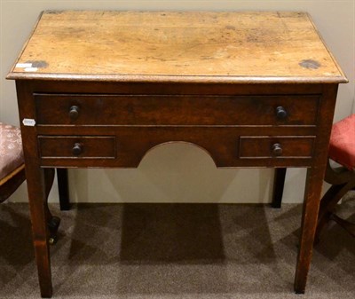 Lot 1435 - A George III oak dressing table, circa 1800, with a long frieze drawer and two small drawers...