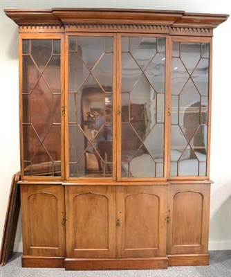 Lot 1441 - Victorian mahogany four door library bookcase, bold pediment above four astragal glazed doors...