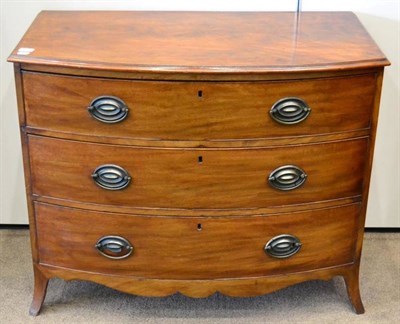 Lot 1447 - A late George III mahogany bow fronted three drawer chest, with shaped apron and raised on...