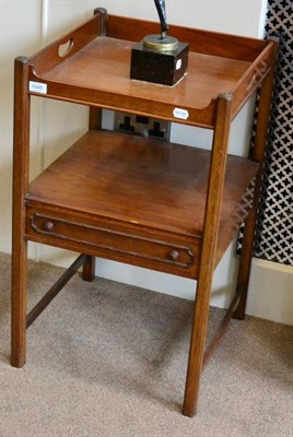 Lot 1448 - ^ A late George III mahogany two tier bedside table, the top tier with pierced carrying...