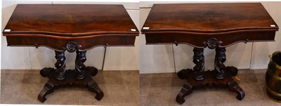 Lot 1457 - A pair of 19th century Irish mahogany foldover card tables, of serpentine shaped form, raised...