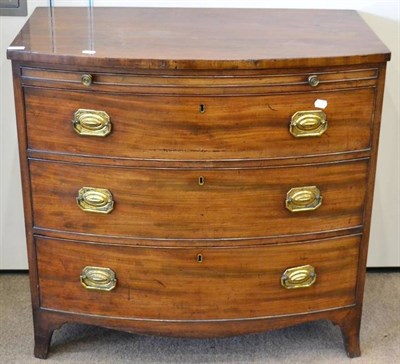 Lot 1460 - ^ A Regency mahogany bow fronted chest of drawers, early 19th century, with a pull out brushing...