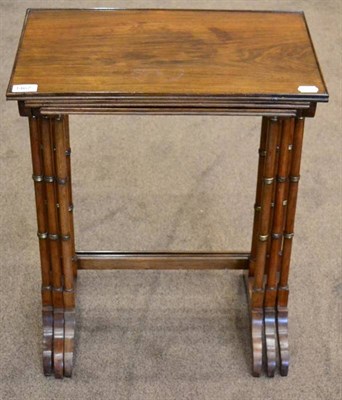 Lot 1467 - A set of three Regency style rosewood nesting tables, late 19th century, of rectangular form raised