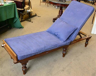 Lot 1475 - A Victorian mahogany and cane seated lounger with adjustable back support, seat and footrest raised