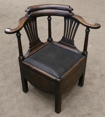 Lot 1491 - An 18th century mahogany commode elbow chair, diameter 79cm