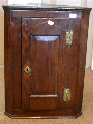 Lot 1493 - An 18th century oak hanging corner cupboard, with moulded cornice above a glazed door, 93cm high