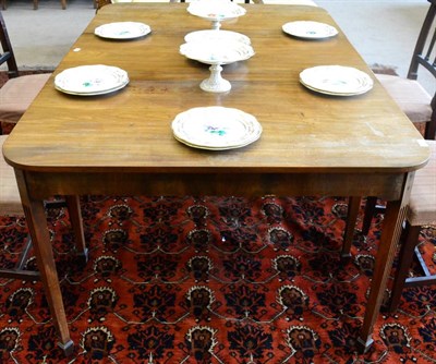 Lot 1500 - ^ A George III mahogany dining table of rounded rectangular form, raised on square fluted...