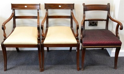 Lot 1507 - A pair of Regency mahogany armchairs, early 19th century, with reeded frames, overstuffed...