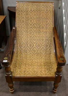 Lot 1515 - A 19th century West Indian hardwood steamer chair, with curved frame and pivoting footrests, raised