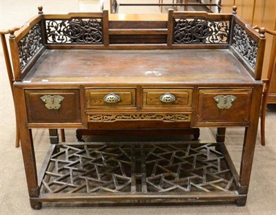 Lot 1517 - A Chinese elm writing table, late 19th/early 20th century with a fret carved gallery above four...