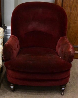 Lot 1524 - A Victorian armchair of large proportions, covered in red velvet, with overstuffed seat, raised...