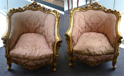 Lot 1527 - A pair of 19th century Louis XIV style carved giltwood bergeres, upholstered in pink, close...