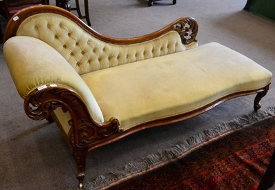 Lot 1541 - A Victorian walnut framed chaise longue recovered in yellow velvet with moulded frame and...