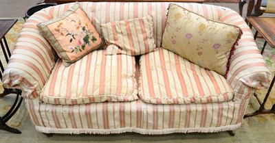 Lot 1544 - ^ A Victorian two seater sofa, mid-19th century, with rounded arm supports and squab cushions...