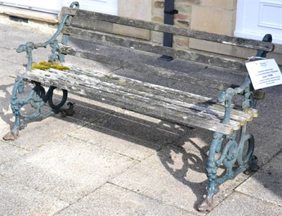 Lot 1598 - A Victorian wooden slatted cast iron garden bench with dog form arms, 151cm wide