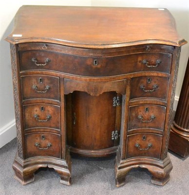 Lot 1607 - ^ A George III style mahogany kneehole desk of serpentine shaped form with pull out writing...