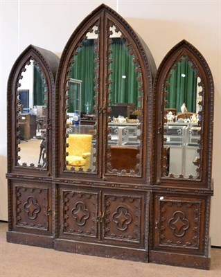 Lot 1609 - A Gothic revival pine wardrobe, late 19th/early 20th century, in three sections, central...