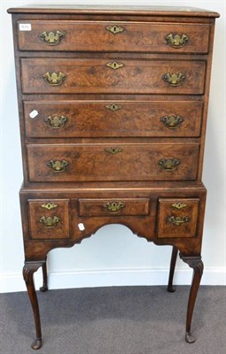 Lot 1615 - ^ An 18th century style walnut and feather banded chest on stand, with four long drawers, the...