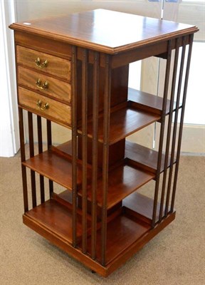 Lot 1618 - An Edwardian mahogany and satinwood banded revolving bookcase, with slatted dividers, three drawers