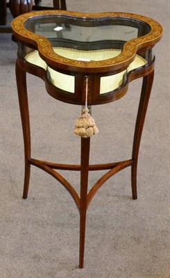 Lot 1619 - An Edwardian mahogany and marquetry inlaid trefold shaped bijouterie table, with glazed hinged...