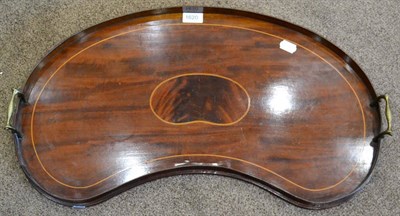 Lot 1620 - An Edwardian mahogany kidney shaped tray with brass carrying handles, 67cm diameter