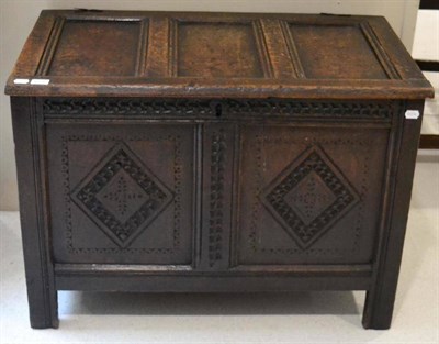 Lot 1624 - A 17th century joined oak chest with hinged lid with lozenge carved panels, 94cm wide