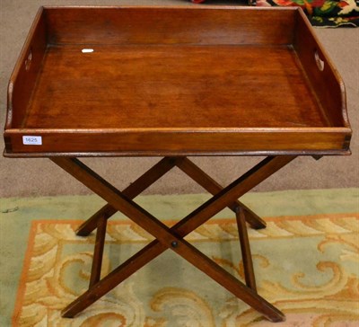 Lot 1625 - A 19th century mahogany butlers tray on folding stand, 74cm wide