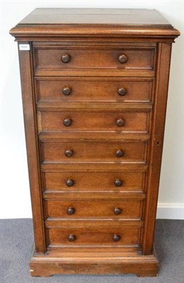 Lot 1626 - A 19th century oak seven drawer Wellington chest, labelled Robert Strahan & Co, Cabinet Makers...