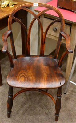 Lot 1628 - A 19th century yew wood armchair, curved splats above shaped arm rests for elm moulded seat, raised