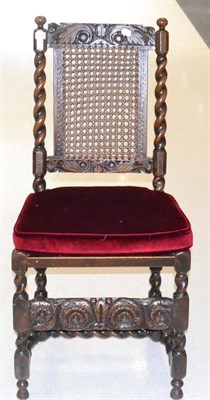 Lot 1629 - A Carolean oak dining chair with cane back support, spiral turned supports and caned seat above...