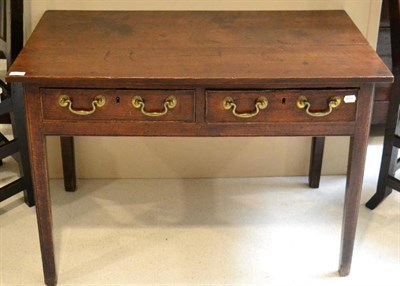 Lot 1632 - A George III joined oak two drawer writing table, late 18th century, with two frieze drawers raised