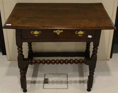 Lot 1643 - A joined oak side table, late 17th century, with single frieze drawer, raised on bobbin and...