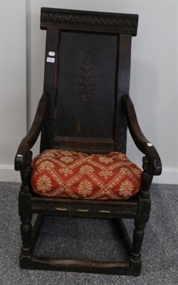 Lot 1644 - A joined oak Wainscot armchair, basically 17th century, with carved top rail above a fielded...