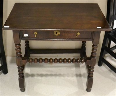 Lot 1648 - A late 17th century joined oak side table, with single frieze drawer, raised on bobbin turned legs