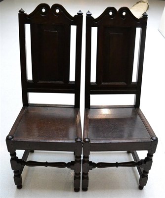 Lot 1651 - A pair of oak joined backstools, probably Lancashire, circa 1700, with panelled back supports above