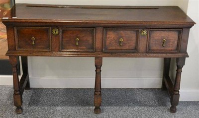 Lot 1653 - A small oak two drawer dresser, with two as one drawers above turned and blocked legs, rear...