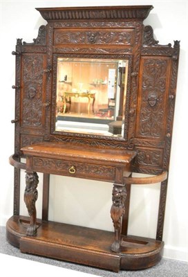 Lot 1655 - A Victorian carved oak hall stand, circa 1870, with a gadrooned pediment and bevelled glass...