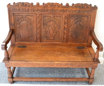 Lot 1657 - Late Victorian carved oak hall bench with carved top rail above three fielded panels, with...