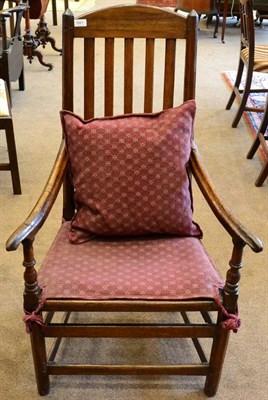 Lot 1661 - An 18th century joined oak armchair, with slatted back support and later boarded seat, raised...